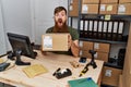 Redhead man with long beard working at small business ecommerce afraid and shocked with surprise and amazed expression, fear and Royalty Free Stock Photo