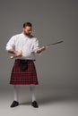 Scottish redhead man in red kilt