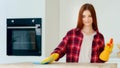 Redhead mistress housewife cleaner active young woman keeping house neat rhythmical wiping kitchen surface in rubber Royalty Free Stock Photo