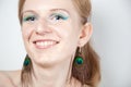 Redhead model with peacock ear-rings