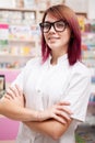 Redhead pharmacist in front of her desk