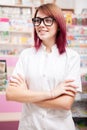 Redhead pharmacist in front of her desk