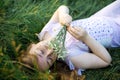 Redhead portrait of a beautiful young sexy red-haired woman, lying in the spring sun, relaxing on the green grass. Royalty Free Stock Photo