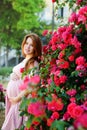 Redhead pregnant womann near the roses