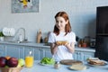 redhead preteen girl holding tasty sandwich