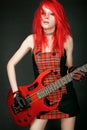 Redhead rocker girl with bass guitar