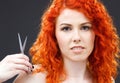 Redhead with scissors Royalty Free Stock Photo