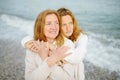 Redhead senior mother and her beautiful adult daughter are walking together and embracing. Family relationships between adult Royalty Free Stock Photo
