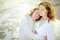 Redhead senior mother and her beautiful adult daughter are walking together and embracing. Family relationships between adult Royalty Free Stock Photo