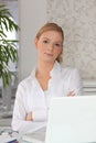 Redhead sitting by her laptop