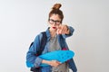 Redhead student woman wearing backpack holding skate over  white background pointing with finger to the camera and to you, Royalty Free Stock Photo