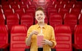 Redhead teenage girl with popcorn at movie theater Royalty Free Stock Photo