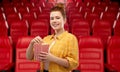 Redhead teenage girl with popcorn at movie theater Royalty Free Stock Photo