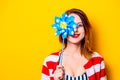 Redhead white woman in shirt with pinwheel Royalty Free Stock Photo