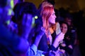 Redhead woman from the audience applauding at Barcelona Accio Musical (BAM)