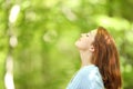 Redhead woman breathing fresh air in a forest Royalty Free Stock Photo