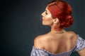 Redhead woman with elegant braided hairstyle isolated over gray Royalty Free Stock Photo