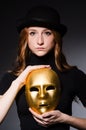 Redhead woman in hat iwith mask in hypocrisy consept Royalty Free Stock Photo