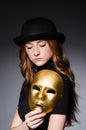 Redhead woman in hat iwith mask in hypocrisy consept Royalty Free Stock Photo