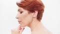 Redhead woman in her 40s posing against white background. Beauty shot Royalty Free Stock Photo