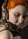 Redhead woman holding snake. close-up photo girl with pygmy python on a white background Royalty Free Stock Photo