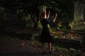 Redhead woman performing ritual at grave