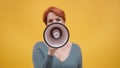 Redhead woman in 40s speaking in loudspeaker Royalty Free Stock Photo