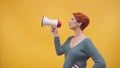 Redhead woman in 40s speaking in loudspeaker Royalty Free Stock Photo