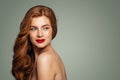 Redhead woman smiling. Red head girl with curly hairstyle looking over shoulder. Natural authentic beauty Royalty Free Stock Photo