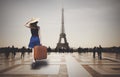 Redhead woman with suitcase come to Paris