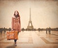 Redhead woman with suitcase come to Paris