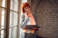 Redhead woman talking on cell phone