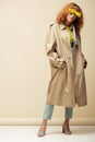 Redhead woman in trench coat and Royalty Free Stock Photo