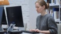 Redhead Woman Typing on Computer in Office