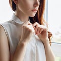 Redhead woman unbuttoning white blouse at home. Royalty Free Stock Photo