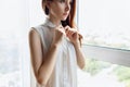 Redhead woman unbuttoning white blouse at home. Royalty Free Stock Photo