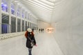 Redhead Woman Walking Through One World Trade Center Ground Floor in New York. Beautiful Minimal White Decoration and Architecture