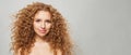 Redhead woman with wavy hair and natural makeup. Fashion model with long curly hairstyle and fresh clear skin posing on white Royalty Free Stock Photo