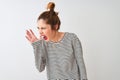 Redhead woman wearing navy striped t-shirt standing over isolated white background shouting and screaming loud to side with hand Royalty Free Stock Photo