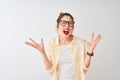 Redhead woman wearing striped shirt and glasses standing over isolated white background crazy and mad shouting and yelling with Royalty Free Stock Photo