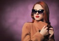 Redhead woman in yellow coat and black sunglasses Royalty Free Stock Photo