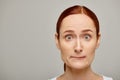 redhead and worried woman in white