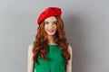 Redhead young happy lady in green dress