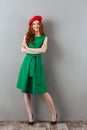 Redhead young happy lady in green dress