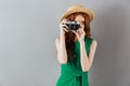 Redhead young lady photographer holding camera. Royalty Free Stock Photo