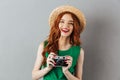 Redhead young laughing lady photographer