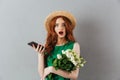 Redhead young shocked woman flowers chatting by phone. Royalty Free Stock Photo