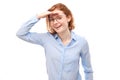 Redhead young woman in business shirt looks future, looking far away distance with hand over head Royalty Free Stock Photo