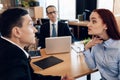 Redheaded angry woman argues with adult man in divorce lawyer`s office. Royalty Free Stock Photo