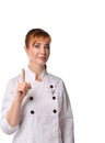 Redheaded female, nurse or doctor, in medical uniform. She raised her forefinger up, posing isolated on white background. Close up Royalty Free Stock Photo